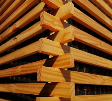 Listones de madera de pino apilados en zigzag secándose, textura veteada natural en Burgos